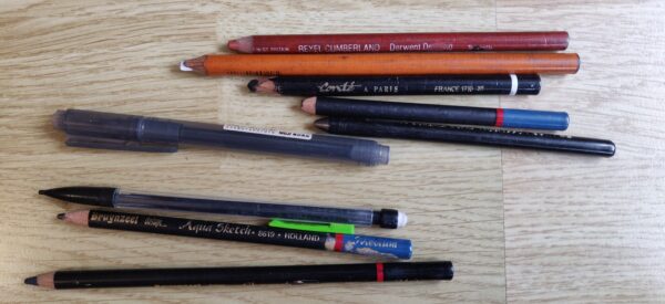 Toutes sortes de crayons et un feutre : sanguine, crayon blanc, pierre noire, mine de plomb, feutre pinceau Muji, criterium, etc.