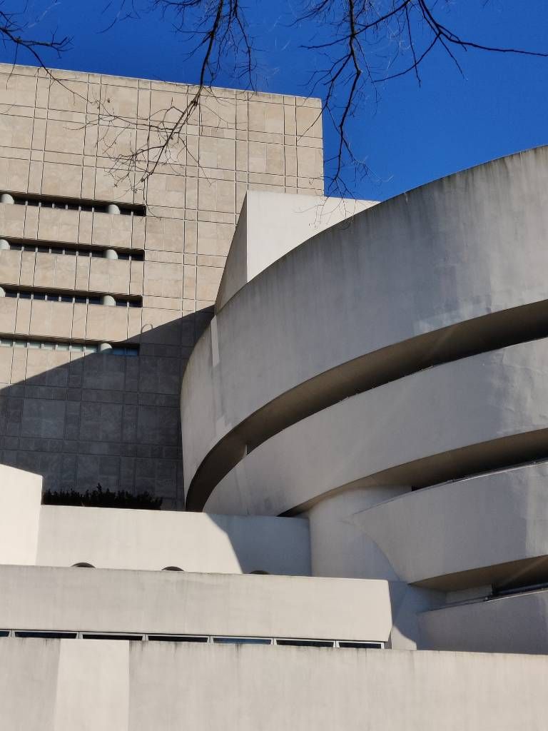 Vue d'une partie de la façade où se mêlent la partie en spirale, la partie horizontale et la partie haute à l'arrière